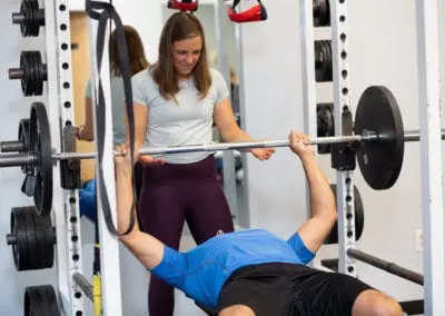 Personal Trainer spotting a man bench pressing