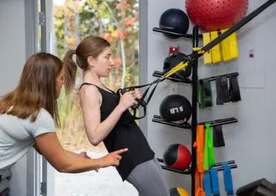 Personal trainer helping with proper form